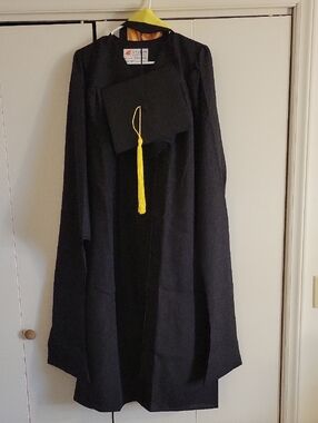 Black Masters Degree Graduation Gown with Cap, Yellow Tassel, and Yellow Sash.
